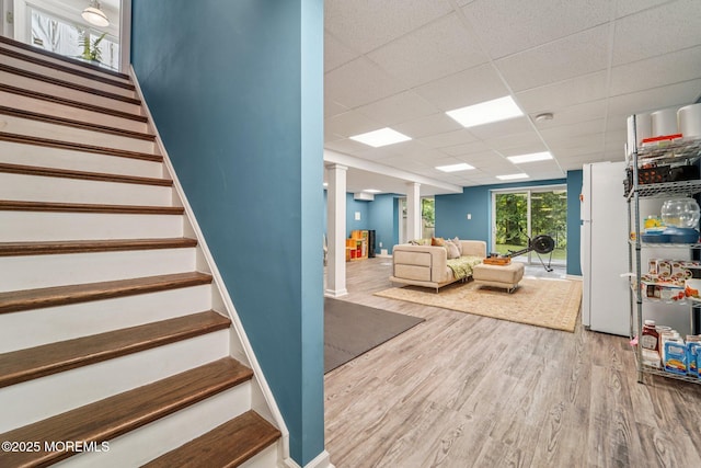 11 Delwood Rd, Chester Twp, NJ 07930 - stairs featuring wood finished floors, a paneled ceiling, and decorative columns