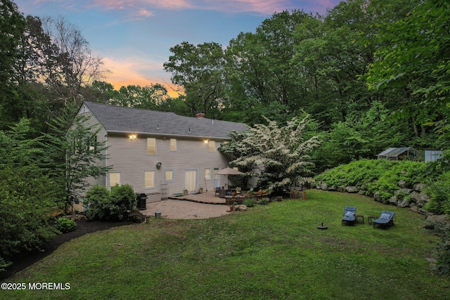 11 Delwood Rd, Chester Twp, NJ 07930 - back of house featuring a patio area, a yard, roof with shingles, and a chimney