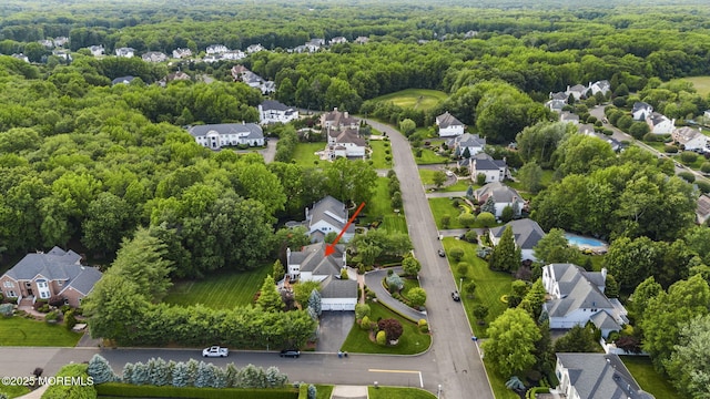 320 Sinclair Ct, Morganville, NJ 07751 - aerial view of residential area featuring a heavily wooded area