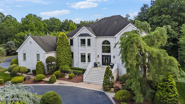 320 Sinclair Ct, Morganville, NJ 07751 - french provincial home with stairs, brick siding, and french doors