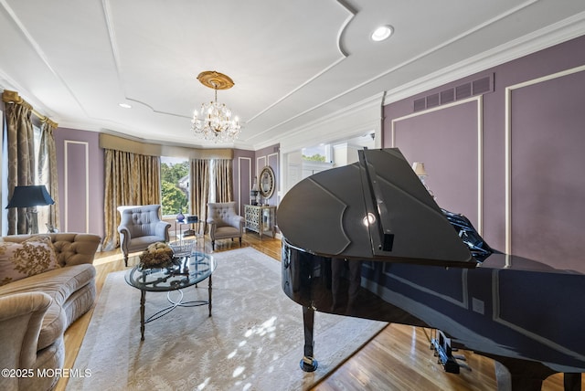 320 Sinclair Ct, Morganville, NJ 07751 - living area with a chandelier, wood finished floors, a tray ceiling, crown molding, and recessed lighting
