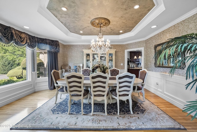 320 Sinclair Ct, Morganville, NJ 07751 - dining room featuring a tray ceiling, a chandelier, light wood-type flooring, wallpapered walls, and a wainscoted wall
