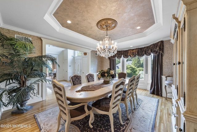 320 Sinclair Ct, Morganville, NJ 07751 - dining area with wallpapered walls, a raised ceiling, light wood-type flooring, a chandelier, and crown molding