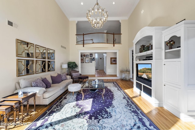 320 Sinclair Ct, Morganville, NJ 07751 - living area with wood finished floors, crown molding, a chandelier, and a high ceiling
