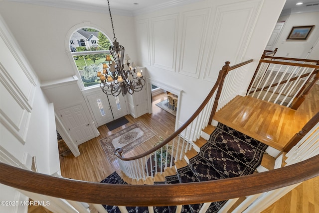 320 Sinclair Ct, Morganville, NJ 07751 - entryway with a chandelier, wood finished floors, stairway, and ornamental molding