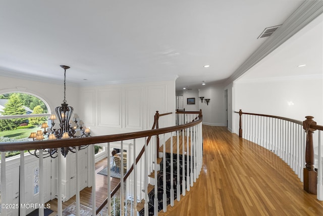 320 Sinclair Ct, Morganville, NJ 07751 - hallway with an upstairs landing, a chandelier, light wood finished floors, recessed lighting, and ornamental molding