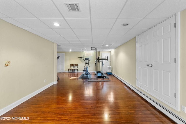 320 Sinclair Ct, Morganville, NJ 07751 - exercise area with wood finished floors, a baseboard heating unit, recessed lighting, and a paneled ceiling