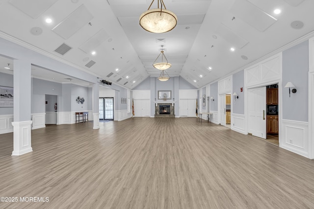 18 Stewart Ct, Jackson, NJ 08527 - unfurnished living room featuring a decorative wall, light wood-style floors, a fireplace, wainscoting, and vaulted ceiling