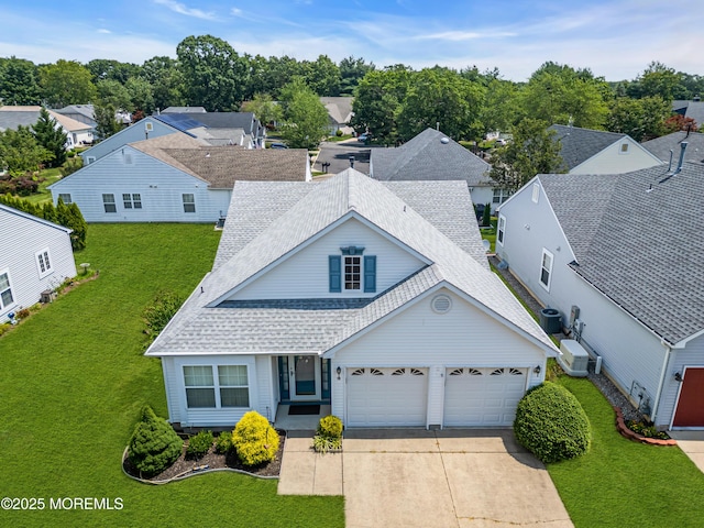 18 Stewart Ct, Jackson, NJ 08527 - view of front of house with roof with shingles, driveway, an attached garage, a front lawn, and a residential view