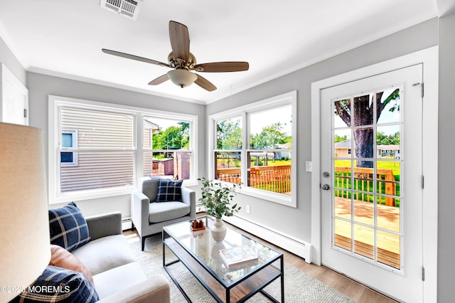 134 Northumberland Dr, Toms River, NJ 08757 - living area with a baseboard radiator, ornamental molding, light wood-style flooring, and a ceiling fan