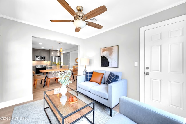 134 Northumberland Dr, Toms River, NJ 08757 - living room featuring a ceiling fan, light wood finished floors, and ornamental molding