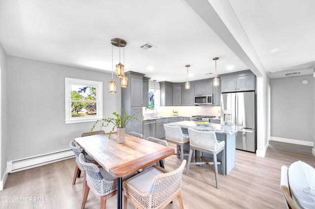 134 Northumberland Dr, Toms River, NJ 08757 - dining area featuring a baseboard radiator, light wood-style floors, and recessed lighting