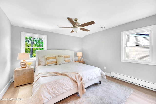 134 Northumberland Dr, Toms River, NJ 08757 - bedroom featuring a baseboard heating unit, wood finished floors, and a ceiling fan