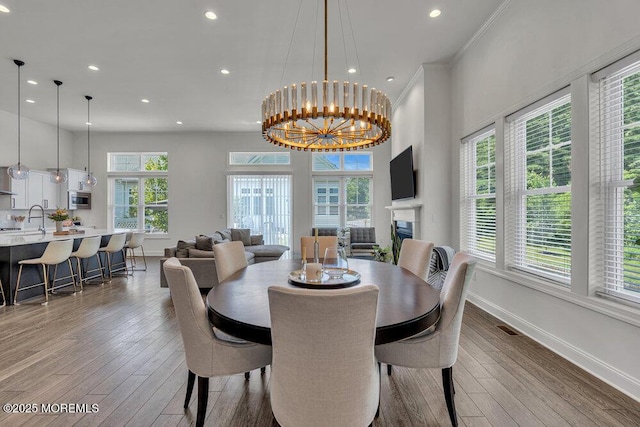 2 Foulks Ter, Lincroft, NJ 07738 - dining room with hardwood / wood-style floors, recessed lighting, crown molding, and a chandelier