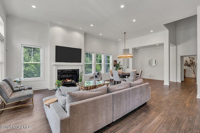 2 Foulks Ter, Lincroft, NJ 07738 - living room with a premium fireplace, dark wood-type flooring, ornamental molding, a chandelier, and recessed lighting