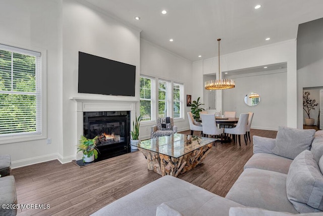 2 Foulks Ter, Lincroft, NJ 07738 - living area with a chandelier, ornamental molding, wood finished floors, a glass covered fireplace, and recessed lighting