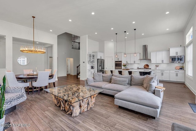 2 Foulks Ter, Lincroft, NJ 07738 - living room with a chandelier, a high ceiling, recessed lighting, and light wood-type flooring