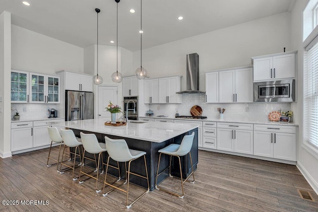 2 Foulks Ter, Lincroft, NJ 07738 - kitchen with stainless steel appliances, wall chimney range hood, white cabinetry, a high ceiling, and recessed lighting