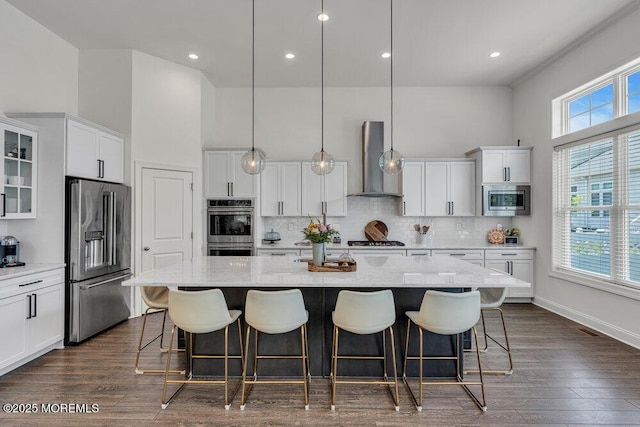 2 Foulks Ter, Lincroft, NJ 07738 - kitchen with appliances with stainless steel finishes, wall chimney range hood, white cabinetry, a kitchen island with sink, and backsplash