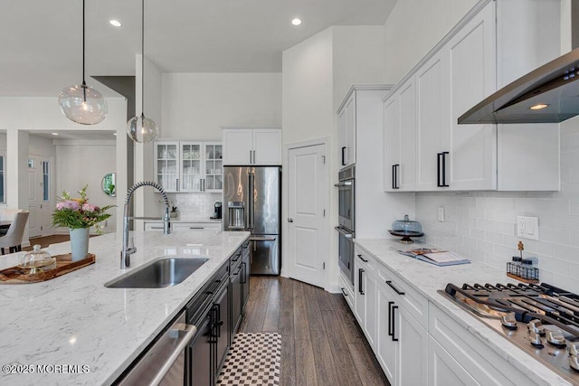2 Foulks Ter, Lincroft, NJ 07738 - kitchen featuring appliances with stainless steel finishes, wall chimney range hood, glass insert cabinets, white cabinets, and light stone countertops