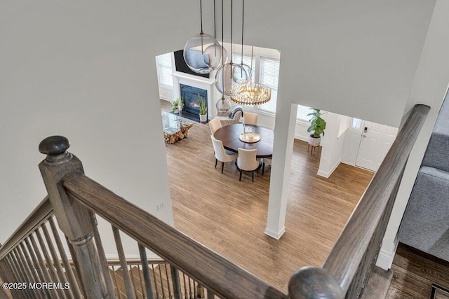 2 Foulks Ter, Lincroft, NJ 07738 - stairs featuring wood finished floors, a fireplace with flush hearth, a chandelier, and a high ceiling