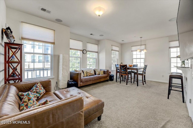2 Michael Dr, Tinton Falls, NJ 07712 - carpeted living room with a chandelier and baseboards