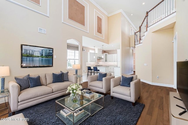 161 Arborridge Dr, Forked River, NJ 08731 - living room with wood finished floors, arched walkways, a high ceiling, and crown molding