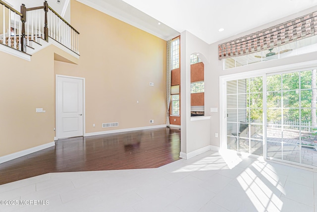 161 Arborridge Dr, Forked River, NJ 08731 - unfurnished room featuring a towering ceiling, recessed lighting, arched walkways, and wood finished floors