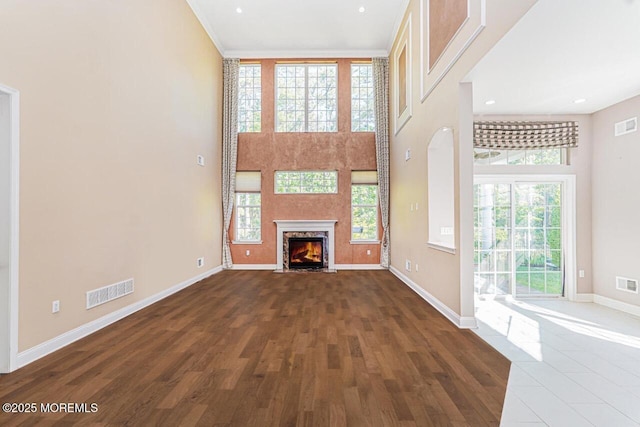 161 Arborridge Dr, Forked River, NJ 08731 - unfurnished living room featuring dark wood-style flooring, a towering ceiling, a fireplace with flush hearth, and recessed lighting