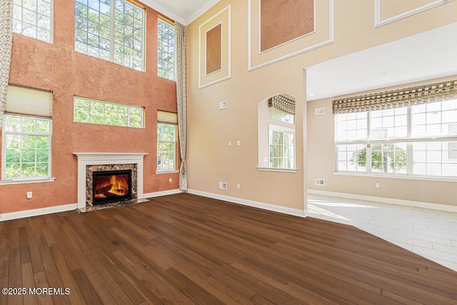 161 Arborridge Dr, Forked River, NJ 08731 - unfurnished living room with dark wood-style flooring, healthy amount of natural light, a high ceiling, and a premium fireplace