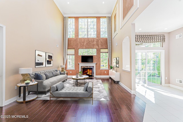 161 Arborridge Dr, Forked River, NJ 08731 - living area featuring dark wood-style floors, a high ceiling, a warm lit fireplace, and recessed lighting