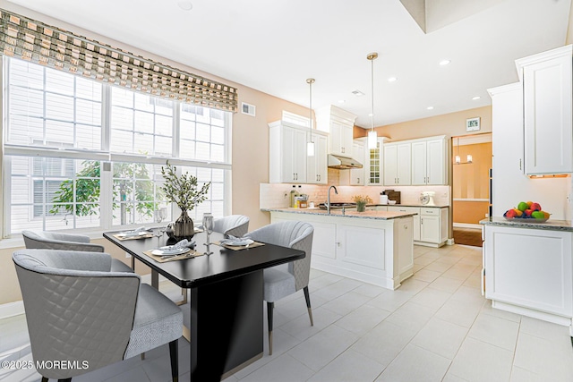 161 Arborridge Dr, Forked River, NJ 08731 - kitchen with tasteful backsplash, white cabinets, under cabinet range hood, hanging light fixtures, and glass insert cabinets