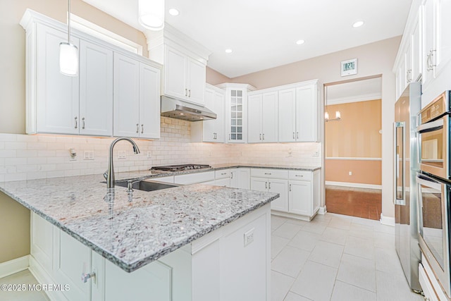 161 Arborridge Dr, Forked River, NJ 08731 - kitchen with a peninsula, under cabinet range hood, decorative backsplash, glass insert cabinets, and white cabinetry