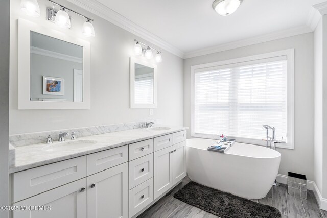 309 Hall Ave, Point Pleasant, NJ 08742 - full bath with double vanity, a freestanding tub, and ornamental molding