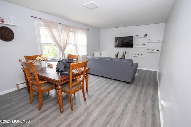364 Westwood Ave Unit 46, Long Branch, NJ 07740 - dining room with wood finished floors and a baseboard radiator