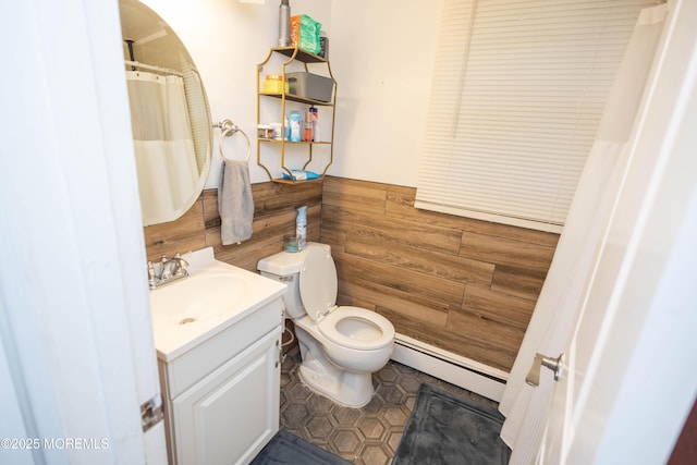 364 Westwood Ave Unit 46, Long Branch, NJ 07740 - bathroom featuring baseboard heating, vanity, and wainscoting