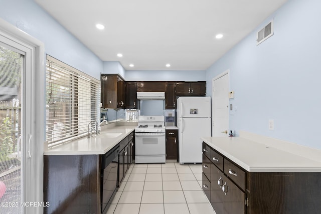 129 Tudor Ct, Lakewood, NJ 08701 - kitchen with white appliances, dark brown cabinetry, light countertops, and recessed lighting