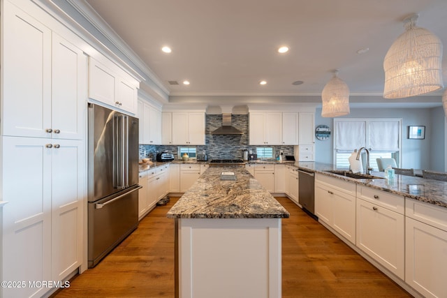 2029 Bay Blvd, Ortley Beach, NJ 08751 - kitchen with stainless steel appliances, wall chimney exhaust hood, ornamental molding, tasteful backsplash, and white cabinets