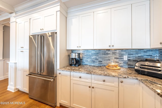 2029 Bay Blvd, Ortley Beach, NJ 08751 - kitchen with high quality fridge, light wood-style floors, tasteful backsplash, white cabinets, and ornamental molding