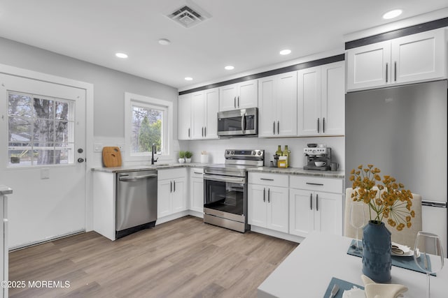 402 Picardy Ct Unit B, Lakewood, NJ 08701 - kitchen with stainless steel appliances, light countertops, white cabinetry, recessed lighting, and light wood-style floors