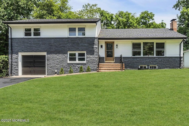 1528 Stuyvesant Ave, Ewing, NJ 08618 - split level home with stone siding, a front lawn, an attached garage, driveway, and a chimney