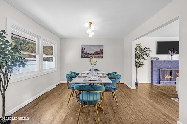 1528 Stuyvesant Ave, Ewing, NJ 08618 - dining space with wood finished floors and a brick fireplace
