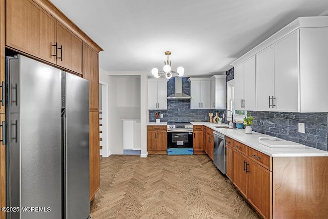 1528 Stuyvesant Ave, Ewing, NJ 08618 - kitchen featuring appliances with stainless steel finishes, wall chimney range hood, tasteful backsplash, light countertops, and a chandelier