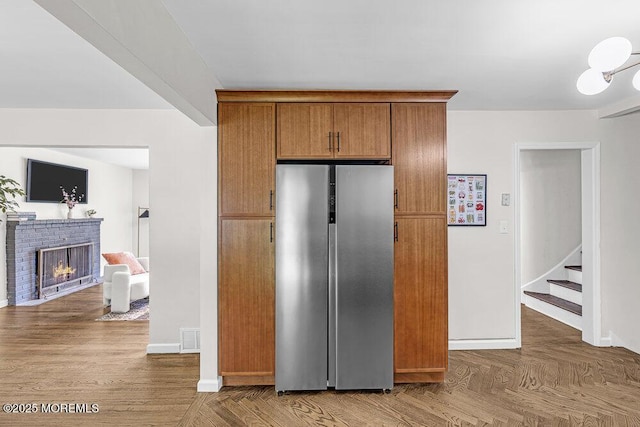 1528 Stuyvesant Ave, Ewing, NJ 08618 - kitchen featuring freestanding refrigerator, brown cabinets, and a fireplace