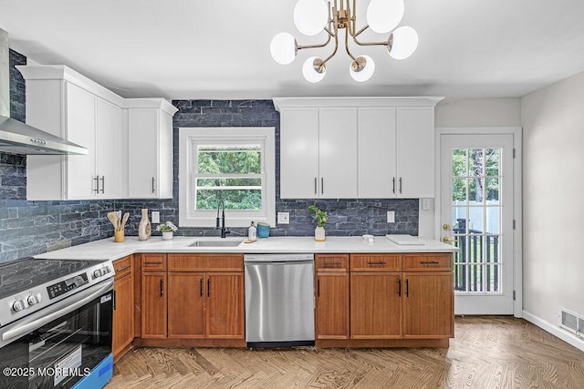 1528 Stuyvesant Ave, Ewing, NJ 08618 - kitchen with appliances with stainless steel finishes, wall chimney exhaust hood, plenty of natural light, and light countertops