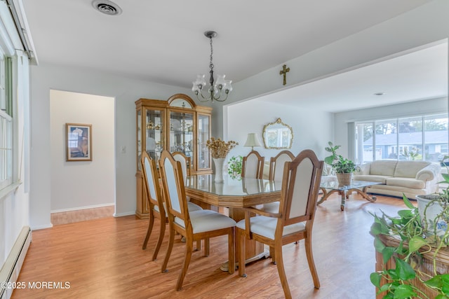 5 Bennington Dr, Toms River, NJ 08757 - dining room featuring baseboard heating, a chandelier, and light wood finished floors