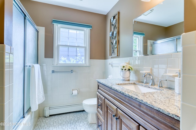 5 Bennington Dr, Toms River, NJ 08757 - bathroom featuring baseboard heating, tile walls, vanity, and a wainscoted wall
