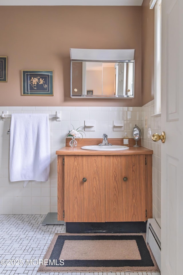 5 Bennington Dr, Toms River, NJ 08757 - bathroom featuring baseboard heating, tile walls, vanity, and wainscoting