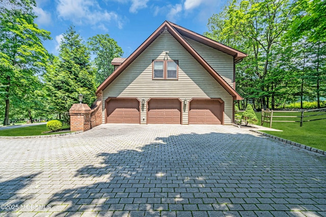 8 Old Dutch Rd, Warren, NJ 07059 - view of home's exterior featuring an attached garage, decorative driveway, and a lawn