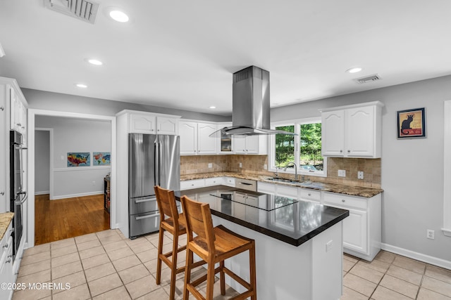 8 Old Dutch Rd, Warren, NJ 07059 - kitchen with stainless steel appliances, island exhaust hood, light tile patterned floors, white cabinetry, and a kitchen breakfast bar